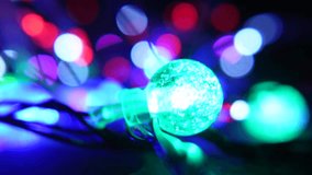 Vibrant multicolor string lights with glowing red and green bulb accents against a soft bokeh background, creating a festive and warm holiday atmosphere. - Powered by Shutterstock - Get 15% off with code: PIKWIZARD15