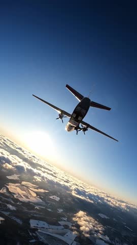 A large military plane and a parachutist jumping out of it against the background of the setting sun, clouds and a snow-covered landscape, aerial view from above.
