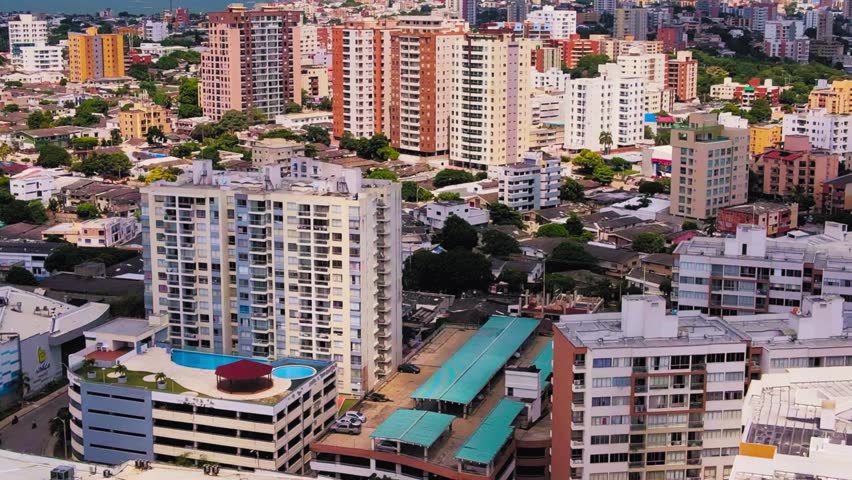 Aerial view of Barranquilla, Colombia, showcasing several modern buildings, urban skyline, and city landscape from above.