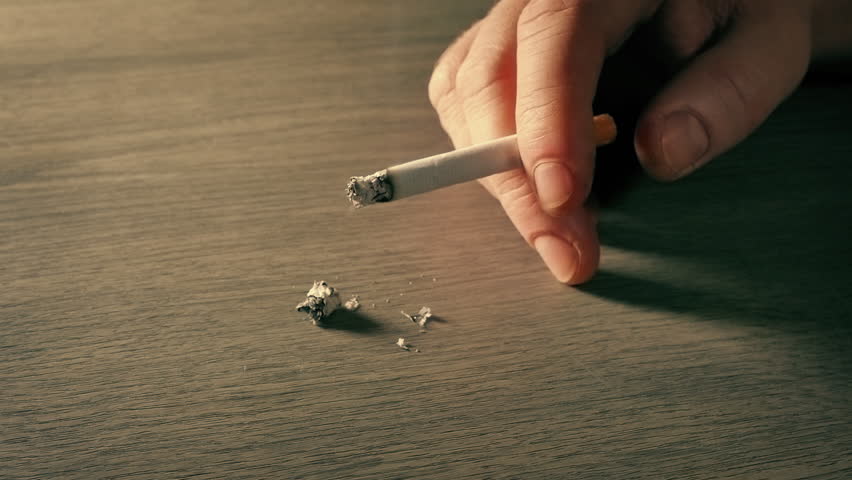 Smoker Hand On Table In Sunlight