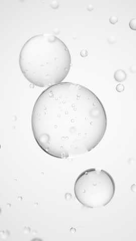 Macro of three drops of transparent liquid merge into one with bubbles inside on white backdrop. Skin care serum droplets uniting into one. Cosmetics moisturizer fluid concept Vertical video
