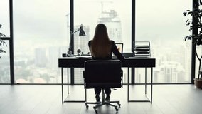 Back view of a businesswoman analyzing graphs on a laptop at a home office, showcasing remote work, entrepreneurship, and professional productivity. - Powered by Shutterstock - Get 15% off with code: PIKWIZARD15