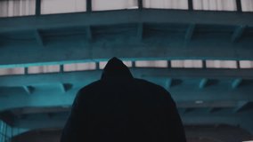 Hooded hacker walking on a dark street near a hideout, evoking suspense and cybercrime tension, captured in cinematic low-light ARRI Alexa Mini footage. - Powered by Shutterstock - Get 15% off with code: PIKWIZARD15