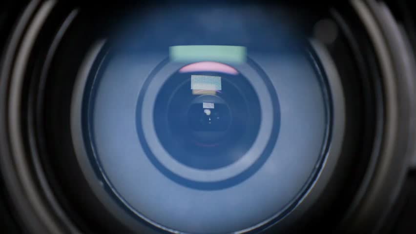 Close-up of a camera lens photographing a meteor shower, zooming as the night sky comes into focus, perfect for astronomy and celestial visuals.