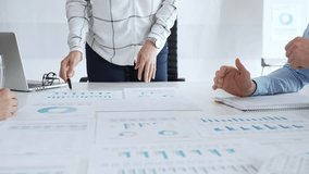 Business team analyzing financial charts during strategy meeting, professionals discussing data and performance metrics at workplace for decision making success - Powered by Shutterstock - Get 15% off with code: PIKWIZARD15