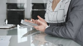 Business professionals discussing data on digital tablet during corporate meeting, collaborating on project strategy. Business people concept - Powered by Shutterstock - Get 15% off with code: PIKWIZARD15