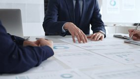 Business professionals discussing financial reports and marketing charts during corporate meeting, focusing on strategy, planning, data analysis, and teamwork - Powered by Shutterstock - Get 15% off with code: PIKWIZARD15