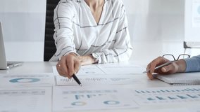 Team collaboration in modern office with financial documents, charts and graphs on desk, professionals discussing strategy, planning, and analysis during meeting. Diverse business people group at work - Powered by Shutterstock - Get 15% off with code: PIKWIZARD15