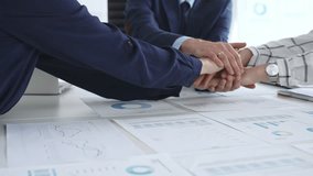 Teamwork and business collaboration with colleagues joining hands over financial charts, symbolizing unity, partnership, success, and strategic corporate planning - Powered by Shutterstock - Get 15% off with code: PIKWIZARD15