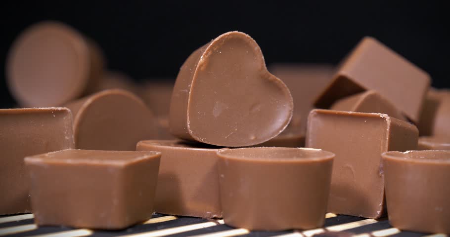 Delicious chocolate candy of different forms, including heart-shaped ones. Chocolate candies. Valentines Day Gift