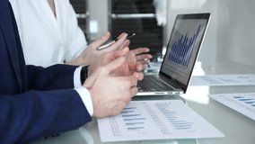 Business professionals examining laptop charts and bar graphs during a modern office meeting, discussing sales performance, market trends, financial analysis and strategy development - Powered by Shutterstock - Get 15% off with code: PIKWIZARD15