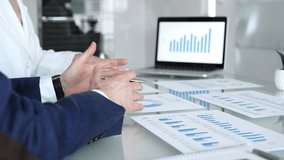 Business people collaborating on financial data analysis, reviewing growth charts on a laptop and printed reports during an important office meeting - Powered by Shutterstock - Get 15% off with code: PIKWIZARD15