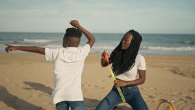 Ecstatic african american mother and son twirling among soap bubbles on sunlit sandy beach, carefree summer bonding, laughter, and joyful seaside play during vacation - Powered by Shutterstock - Get 15% off with code: PIKWIZARD15