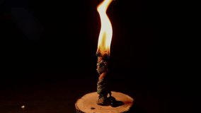 Closeup a bright fire light of power burning twisted ritual program magic candle flame in a dark. The sorcerer performs a magical rite with candles. Witchcraft and magic. mystical ritual with a spell. - Powered by Shutterstock - Get 15% off with code: PIKWIZARD15