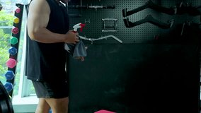 Man Sanitizing Gym Bench with Spray Bottle and Cloth - Powered by Shutterstock - Get 15% off with code: PIKWIZARD15