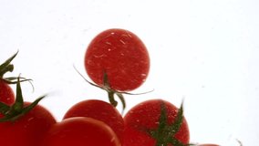 Close-up fresh red cherry tomatoes moving and splashing in water in slow motion - Powered by Shutterstock - Get 15% off with code: PIKWIZARD15