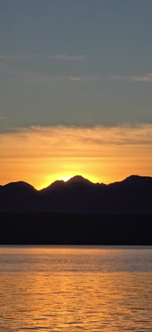Sunset behind the Olympic mountains over the Hood Canal in Poulsbo, Washington 