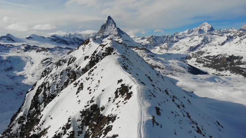 Stunning aerial view of a snow-covered mountain ridge with dramatic peaks.