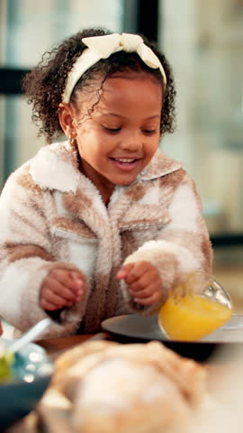 Accident, mess and orange juice with reaction of girl child in home dining room for oops. Glass, mistake and spill with clumsy kid at table in apartment for dinner time, family meal or thanksgiving