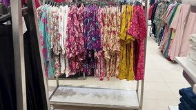 colorful printed kurtis displayed on retail clothing rack in fashion store - Powered by Shutterstock - Get 15% off with code: PIKWIZARD15
