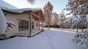 Snow-covered house in a wintry landscape. Evergreen trees stand amidst fresh snow, creating a serene, cold scene. - Powered by Shutterstock - Get 15% off with code: PIKWIZARD15