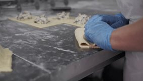 Gloved Hands Wrapping Meat in Puff Pastry. Bakery production - Powered by Shutterstock - Get 15% off with code: PIKWIZARD15