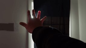 Man Hand In Sunbeam Reaching Out From Shadowed Room. Close-Up Cinematic Moment Capturing Fingers Extended Toward Warm Light Entering Through The Window. - Powered by Shutterstock - Get 15% off with code: PIKWIZARD15