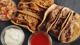 Delicious tasty taco with stewed beef and beans, spicy sauce Valentina and creamy sauce, sauce pico de gallo. Mexican cuisine concept. High quality 4k footage - Powered by Shutterstock - Get 15% off with code: PIKWIZARD15