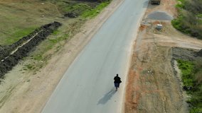 Man Cycling on Asphalt Road Passing a Truck While Drone Follows – Dynamic Aerial Footage - Powered by Shutterstock - Get 15% off with code: PIKWIZARD15