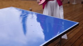 Ping-pong game, group of friends playing ping pong in a park,  play table tennis, family game in the backyard, colleagues teammates during competition at work, racket and ball on a blue tennis table - Powered by Shutterstock - Get 15% off with code: PIKWIZARD15