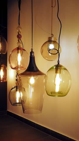Chandeliers in store. assortment of illuminators for interior design. Many different types and shapes of lamps, chandeliers in store showroom. light interior decoration.