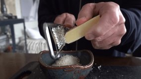 Stockholm, Sweden A cook grates cheese into a bowl. - Powered by Shutterstock - Get 15% off with code: PIKWIZARD15