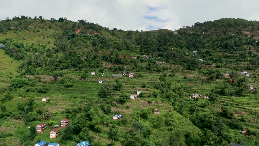 Breathtaking 4K drone shot of lush green landscapes and traditional farming terraces in the Himalayan foothills of Nepal. Nature and village life clip