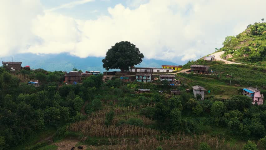 Wide angle aerial shot of a deep river valley surrounded by cultivated hills and forests. Majestic landscape of the Himalayan foothills in 4K quality