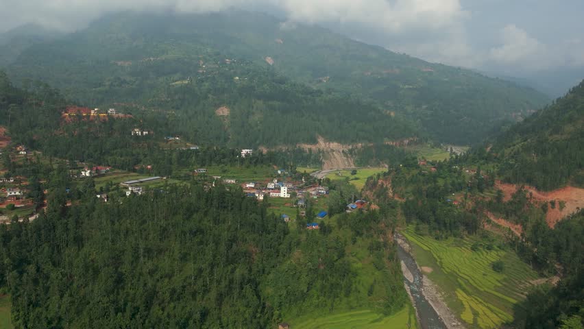 Breathtaking aerial panorama of green hills, deep valleys, and cloudy skies. Majestic nature scenery of the Himalayan foothills in 4K UHD video clip