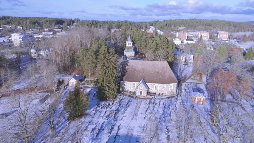 Close-Up of Piikkiö Church Steeple and Rooftops in Early Winter Snow.