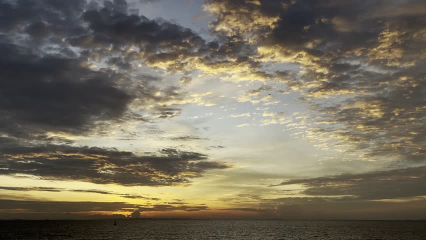 Beautiful sunset over the sea with combination of orange and grey sky