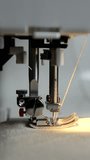 Side View of Sewing Machine Stitching with Light Thread. Viertical Video - Powered by Shutterstock - Get 15% off with code: PIKWIZARD15
