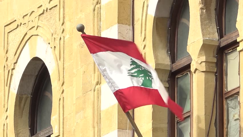 06-08-2025 shoting in Beirut, Lebanon,f lag is a horizontal triband of two red stripes enveloping a central white stripe. Centered on the white stripe is a green cedar of Lebanon tree.