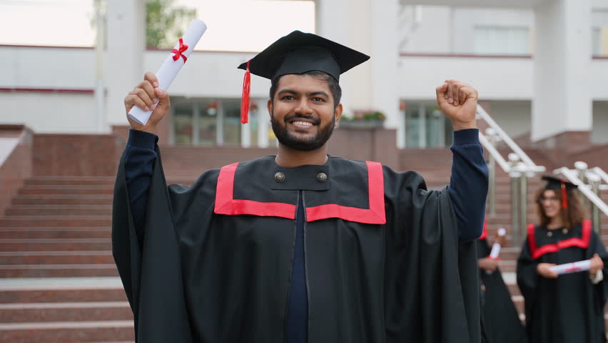 Happy Indian graduate student celebrating university commencement