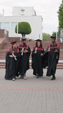 Diverse group of graduates celebrating and walking after the ceremony - Powered by Shutterstock - Get 15% off with code: PIKWIZARD15