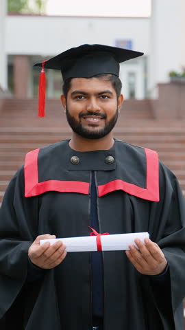Happy Indian graduate student holding diploma