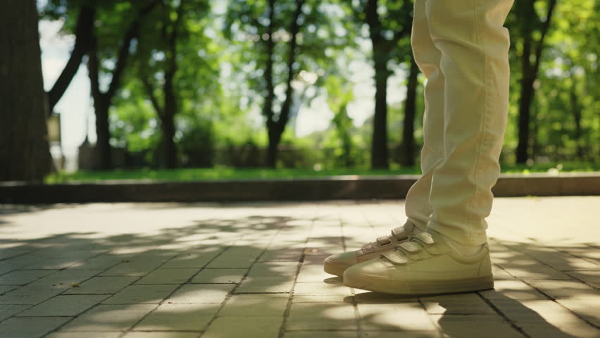 Young couple standing close in park, kissing during romantic date outdoors