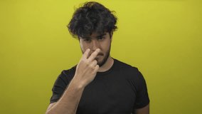 Man with beard making gestures on a yellow background, emphasizing vigilance and intensity, perfect for themes of attention, focus, and communication. - Powered by Shutterstock - Get 15% off with code: PIKWIZARD15
