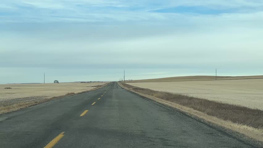 Empty Rural Road POV Driving Through Peaceful Prairie Farmland