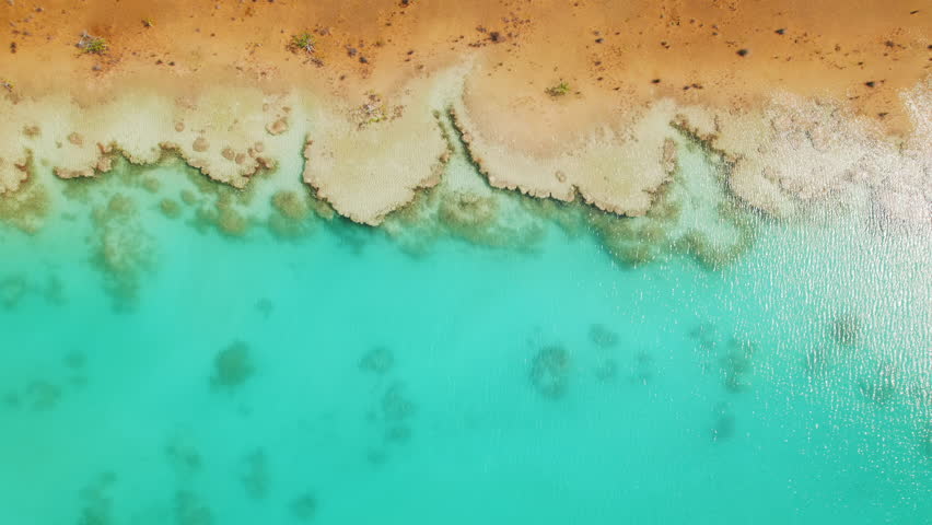 Aerial Bacalar Lagoon shoreline in Mexico showing clear turquoise waters with stromatolite formations