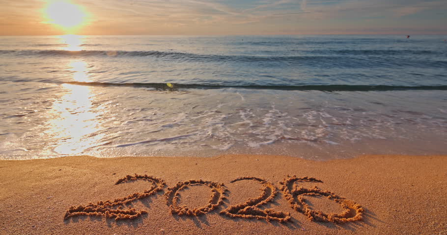 2026 new year on the sand and beautiful sunrise over sea horizon