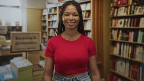 Woman smiling with exposed midriff and braided hair, standing before bookshelves in a library; confidence curiosity. - Powered by Shutterstock - Get 15% off with code: PIKWIZARD15