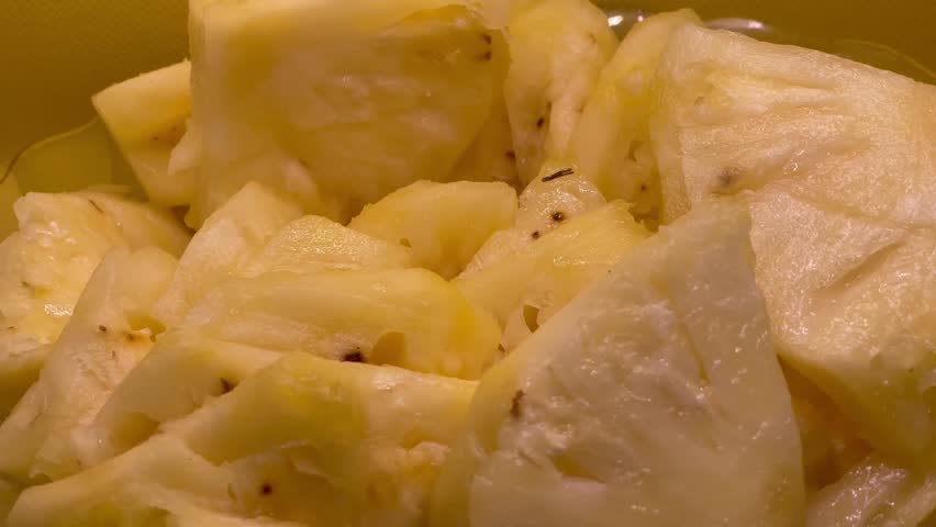 Tropical Pineapple Pieces Against Bright Yellow Backdrop