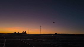 Winter airfield at dawn: silhouettes of airplanes and towers, an airliner taking off in the sky and a thin moon on the background of a bright horizon.
 - Powered by Shutterstock - Get 15% off with code: PIKWIZARD15